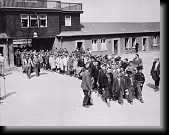 American soldiers escort children survivors of Buchenwald out of the main gate of the camp. * American soldiers escort children survivors of Buchenwald out of the main gate of the camp.Among the children pictured is future Nobel Peace Prize winner Elie Wiesel (fourth child in the left column) * 469 x 370 * (57KB)